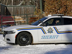A sheriff watches a property in Wetaskiwin County on Wednesday, Nov. 6, 2019, when the Alberta government announced its initial plan to combat rural crime in Alberta.