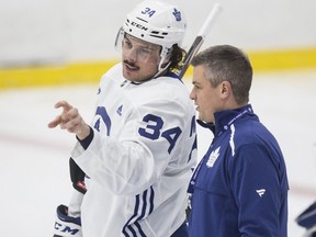 Maple Leafs head coach Sheldon Keefe and Auston Matthews talk at practice at the Ford Performance Centre in Toronto on Monday, Nov. 25, 2019.