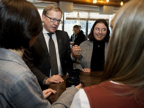 NDP advanced education critic David Eggen chats with MacEwan University students on Wednesday, Dec. 18, 2019, prior to a news conference where he and post-secondary students demanded the UCP reverse funding cuts.