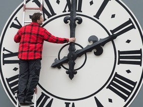 Picture taken on March 23, 2018 shows a technician working on the clock of the Lukaskirche Church in Dresden, eastern Germany. - The European Commission will recommend EU member states abolish daylight saving, where clocks are advanced by one hour in summer, its president Jean-Claude Juncker said on German television on August 31, 2018.