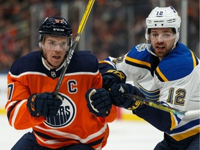 Edmonton Oilers' Connor McDavid (97) battles St. Louis Blues' Zach Sanford (12) during the second period of a NHL hockey game at Rogers Place in Edmonton, on Wednesday, Nov. 6, 2019.