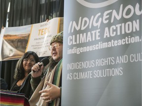 From left, Batul Gulamhusein with Climate Justice Edmonton and Nigel Henri Robinson with Beaverhills Warriors held a press event to call on the Federal Environment Minister Jonathan Wilkinson to reject the proposal and recommended approval of the Teck Frontier Mine in Northern Alberta on Nov. 22, 2019.