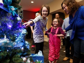 Kate Friesen (second from right) and her family see her Frozen themed Christmas tree for the first time during the inaugural Trees of Joy event organized by Children's Wish Foundation, Alberta & NWT Chapter, at Edmonton International Airport, on Friday, Nov. 29, 2019.