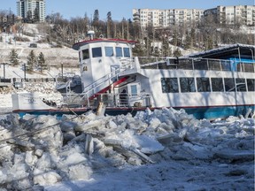 The Edmonton River Queen appears to be beached on large chunks of river ice on December 5, 2019. The boat is listing slightly to the starboard side.  Photo by Shaughn Butts / Postmedia