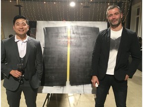 Jay Llanos (left) and Juro Kralovic stand in front of one of Kravolic's Juro Love pieces during a CMHA fundraiser