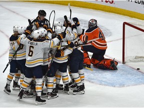 Buffalo Sabres celebrate their overtime goal by Colin Miller (33) on Edmonton Oilers goalie Mike Smith (41) during NHL action at Rogers Place in Edmonton, December 8, 2019.
