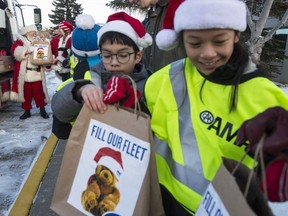 Throughout the year, Alberta Motor Association staff and nearly one-million members have been supporting community food banks through AMA's Fill Our Fleet campaign.  Staff of the south Edmonton location formed a human chain to pass the food donations to a flatbed truck on December 9, 2019