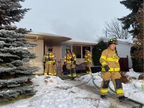 Edmonton firefighters tackle a basement fire at a home in west Edmonton on Tuesday, Dec. 10, 2019.