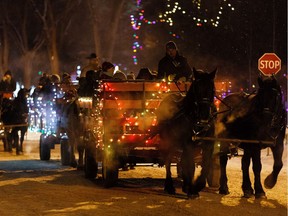 Revelers take a horse drawn sleigh ride during the first-ever Car-free Night at Candy Cane Lane in the Crestwood neighbourhood of Edmonton, on Thursday, Dec. 12, 2019. The event, which is over 50 years old, is a fundraiser for Edmonton's Food Bank.