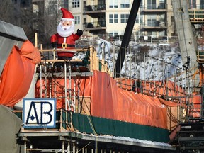 An inflatable Santa sits atop the under construction Tawatinâ Bridge on the Valley Line LRT in Edmonton, December 16, 2019.
