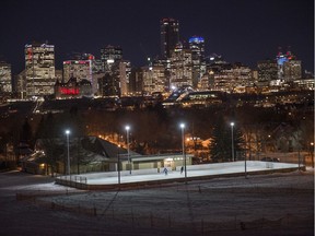 The skyline of Edmonton twinkles in the early evening light with the Cloverdale community rink on December 18, 2019.