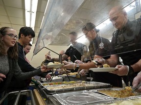 Teachers and police officers served Christmas dinner at L.Y. Cairns School on Thursday, Dec. 19, 2019. The annual Christmas feast for 400 students started at L.Y. Cairns School 50 years ago and was served by staff and school resource officers from the Edmonton Police Service.