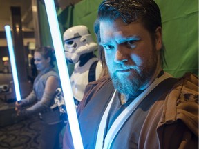 Ryan Buehler dressed as Obi-Wan Kenobi. Movie patrons were able to  take photos with Star Wars characters with props on at the Landmark Theatre in Edmonton City Centre prior to the screening of Star Wars: The Rise of Skywalker on Thursday, Dec. 18, 2019.