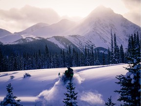A snowmobiler riding in the Kakwa region of the North Rockies.