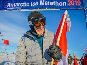 Roy Svenningsen, 84, set a world record this month by becoming the oldest runner to finish a 42-km marathon in Antarctica. He is seen here crossing the finish line with a Canadian flag a spectator handed him.