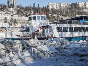 The Edmonton River Queen appears to be beached on large chunks of river ice on December 5, 2019. The boat is listing slightly to the starboard side.  Photo by Shaughn Butts / Postmedia