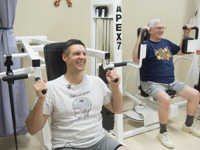 James Leskiw, 42, left, participates in the Alberta Cancer Exercise program at the University of Alberta’s Cancer Rehabilitation Clinic with his father Terry Leskiw, 73, who is a cancer survivor, on Tuesday,  Dec. 10, 2019.