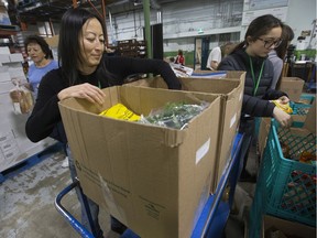 Volunteers pack food hampers at Edmonton's Food Bank, 11508 120 St., in Edmonton on Nov. 12, 2019.