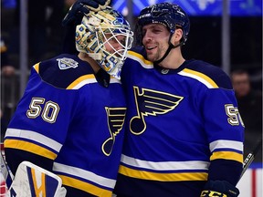 St. Louis Blues left winger David Perron celebrates with goaltender Jordan Binnington after the Blues defeated the Colorado Avalanche on Dec. 16, 2019, at Enterprise Center.