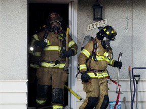 Firefighters work at the scene of a house fire at 15405 80 Ave., Tuesday Dec. 10, 2019.