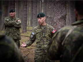 Colonel Bob Ritchie and Chief Warrant Officer Darren Hessell address 1 Canadian Mechanized Brigade Group (1 CMBG) soldiers deployed on Operation REASSURANCE in Latvia, October 2019.