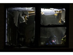 Firefighters work at the scene of a fire at the Jasper Place Hotel, 15326 Stony Plain Rd., in Edmonton on Monday, Dec. 23, 2019.