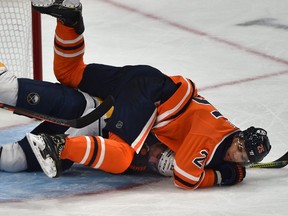 Edmonton Oilers Darnell Nurse (25) hauls down Buffalo Sabres Conor Sheary (43) during NHL action at Rogers Place  in Edmonton, December 8, 2019.