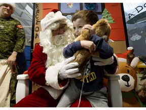 Teddy Toth, 4, receives a teddy bear from Santa Claus at the Stollery Children's Hospital, in Edmonton Wednesday Dec. 11, 2019. Santa was flown in to the hospital by the Edmonton Garrison's 408 Tactical Helicopter Squadron (THS). Squadron personnel donated more than $1,000 to purchase more than 100 teddy bears to bring to the children at the hospital.