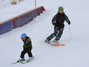 Olympic freestyle skiing medallist Jennifer Heil and her son Mikko Gauthier, 4, left, joined members of the public at the grand re-opening of the Edmonton Ski Club on Thursday, Dec. 26, 2019.