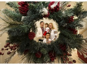 Ostap Sokha, Liliya Sokha and their children Emilia, 2, and Maksym, 7, are framed by a Christmas wreath as they prepare to celebrate Ukrainian Christmas.