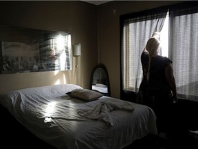 An employee looks out the window at a body rub centre in Edmonton.