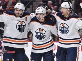 Ryan Nugent-Hopkins #93 of the Edmonton Oilers (C) celebrates a goal with teammates Leon Draisaitl #29 (L) and Alex Chiasson #39 (R) during the third period against the Montreal Canadiens at the Bell Centre on Thursday, Jan. 9, 2020.