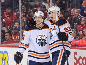 Ryan Nugent-Hopkins, right, of the Edmonton Oilers celebrates with Kailer Yamamoto after scoring against the Calgary Flames at Scotiabank Saddledome on Jan. 11, 2020, in Calgary.