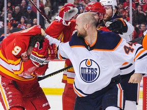 Zack Kassian of the Edmonton Oilers pummels Matthew Tkachuk during the Battle of Alberta at Scotiabank Saddledome on Jan. 11, 2020.