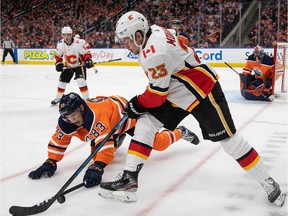 Matt Benning of the Edmonton Oilers battles against Sean Monahan of the Calgary Flames at Rogers Place on Jan. 29, 2020.