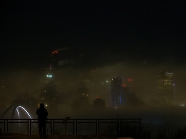 A photographer takes photos of an ice fog hanging over downtown Edmonton early Wednesday Jan. 15, 2020. Photo by David Bloom