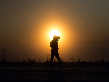 A pedestrian walks along 101 Avenue near 95A street as the Sun rises through a heavy icy fog, in Edmonton Wednesday Jan. 15, 2020. Photo by David Bloom