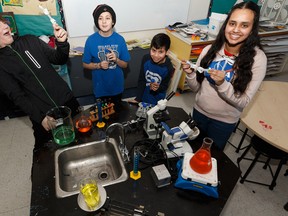 Highlands and Rosslyn school students Adrien Hanna, left, Maddy Keown, Bradley Vith and Sofia Sejutee show their experiment on Thursday, Jan. 30, 2020, involving brine shrimp being sent to the International Space Station through the Student Spaceflight Experiment Program.