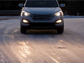 A Hyundai SUV is driven along a slippery, icy road at Ada Boulevard and 75 Street as the sun sets on a cold evening in Edmonton, on Tuesday, Nov. 5, 2019.