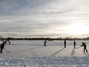 Skaters play shinny at Castle Downs Park on New Year's Eve in Edmonton, on Tuesday, Dec. 31, 2019.