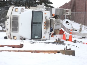 Edmonton fire crews respond to the scene of a tipped over bucket truck near 75 Street and 125 Avenue on Friday, Jan. 3, 2020.