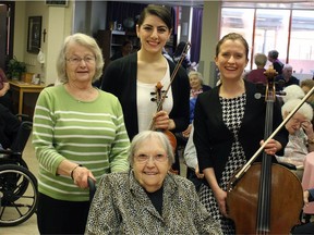 Neda Yamach (violin, centre) and Meran Currie-Roberts (cello, right) at Shepherdís Care Millwoods Manor for a Concert in Care event. Supplied