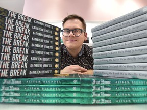 Matthew Stepanic, co-owner of the Glass Bookshop shows off some of the favourite books in his book club, at City Centre Mall in Edmonton, January 8, 2020. Ed Kaiser/Postmedia