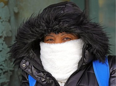 Lucy Cruz waits for a bus on Jasper Avenue in downtown Edmonton on Tuesday January 14, 2020, when temperatures dropped to -43C degrees with the wind chill. Unseasonably cold temperatures are expected for the rest of the week in the Edmonton region.