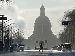 A pedestrain walks along 100 Avenue as the city is still in a deep freeze in Edmonton, January 15, 2020.