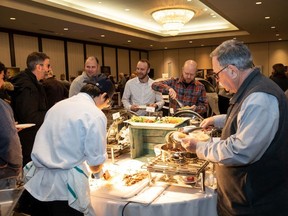 People enjoy snacks during the Edmonton Whisky Festival at the Delta Edmonton South on Wednesday, Jan. 15.