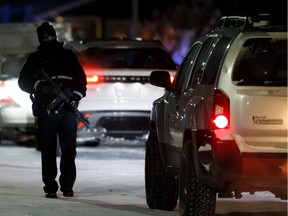 Edmonton Police Service officers maintain a roadblock near Lymburn School after a man assaulted two men and was blockaded in a home near 188 Street and 72 Avenue in Edmonton, on Friday, Jan. 17, 2020.