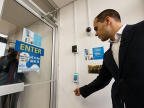 Alberio Bathory-Frota, CEO of Launchcode, demonstrates the use of the Patronscan ID scanning system his company has developed after a government of Alberta press conference announcing a working group on liquor store theft at Ace Liquor in Edmonton, on Monday, Jan. 20, 2020.