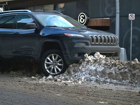 A driver got hung up on the crown of a windrow in downtown in Edmonton, January 23, 2020.