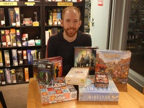 Table Top Cafe owner Brian Flowers with an assortment of Edmonton's most popular board games.